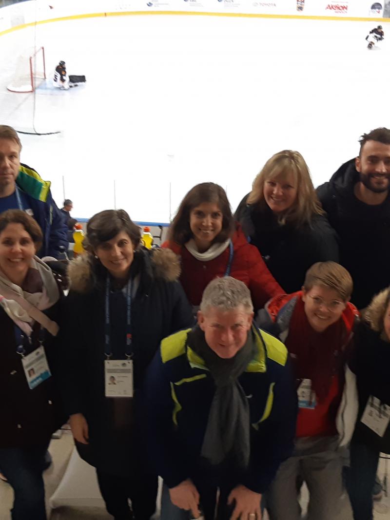 Group  photo of meeting members inside an ice arena