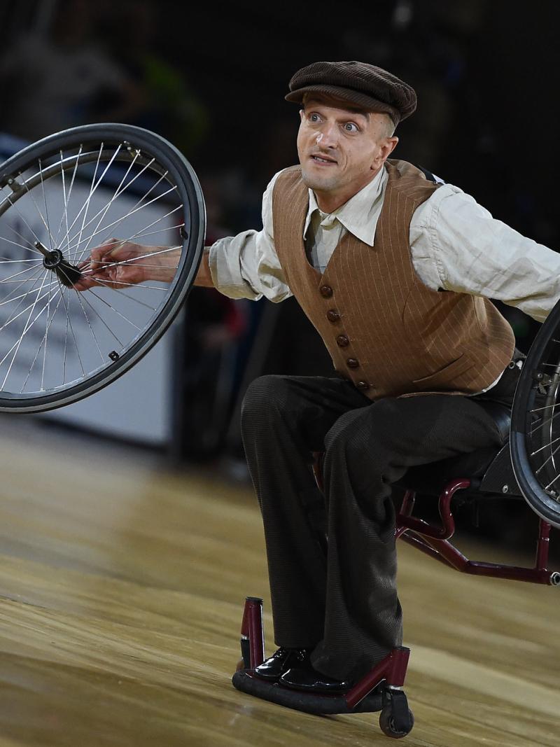 Male Para dance removes wheels in wheelchair