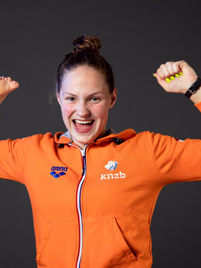 A woman smiling and stretching her arms 