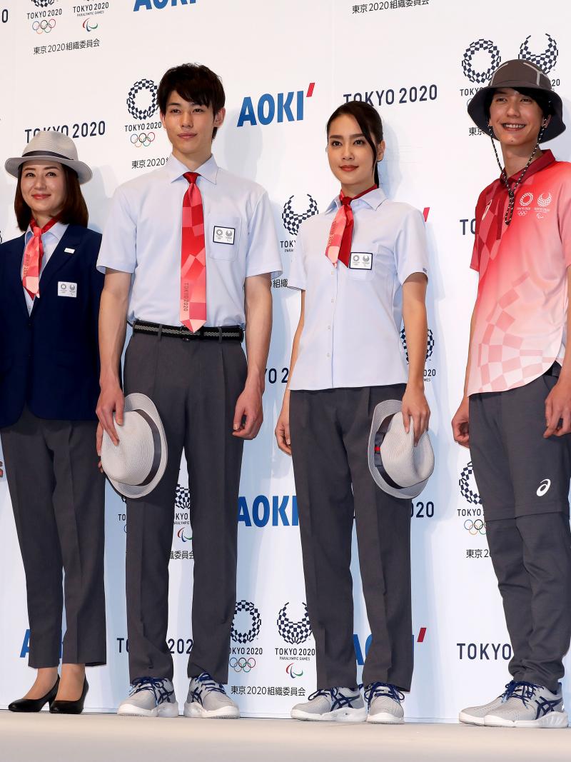 Models posing with Tokyo 2020 technical officials uniforms