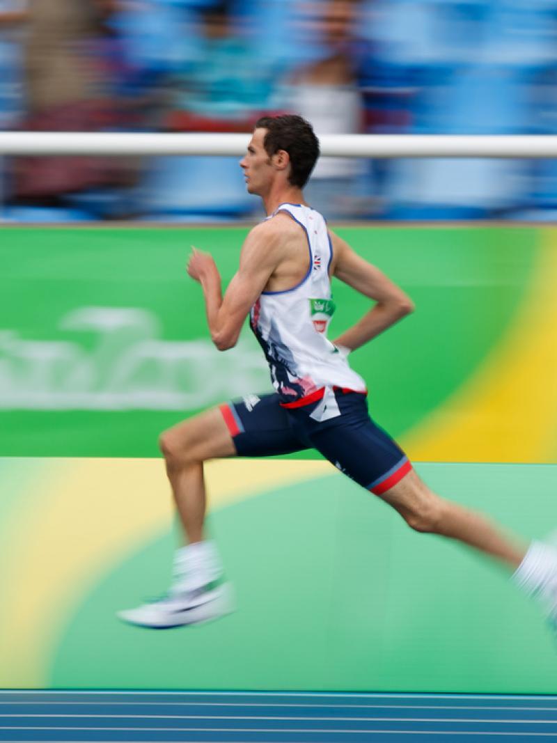 A man running on an athletics track