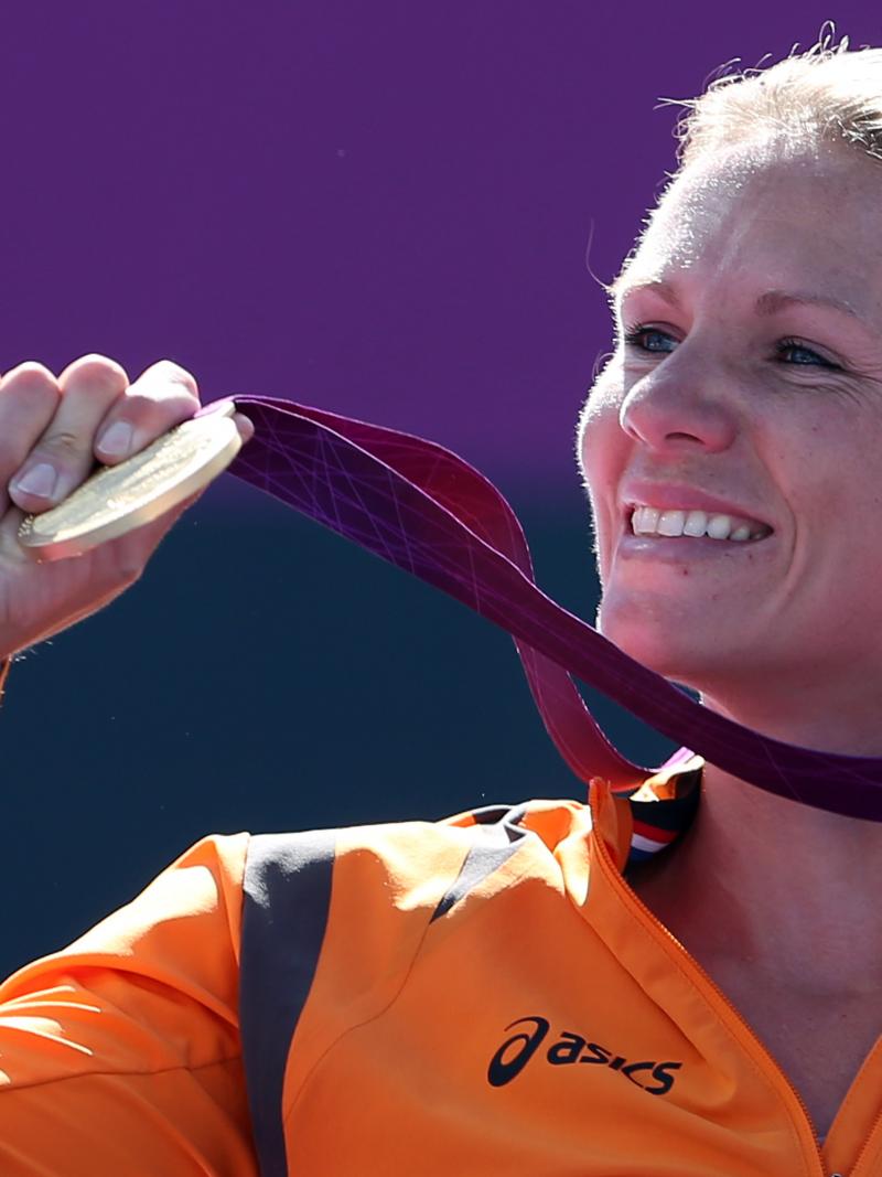 Dutch wheelchair tennis player smiles holding her gold medal at the London 2012 Paralympics