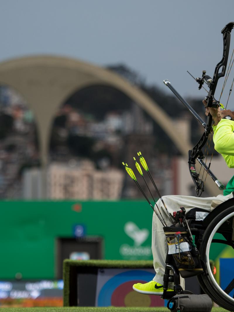 Brazilian male archer in his wheelchair aiming at the target