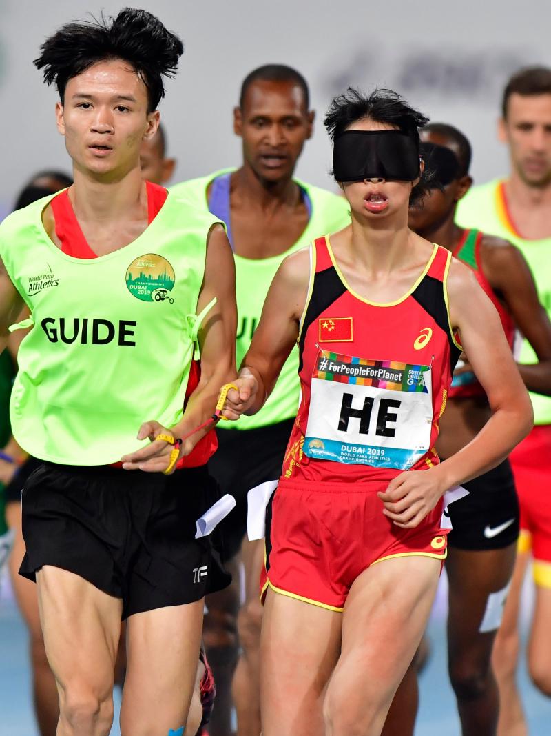 Chinese vision impaired runner with her guide