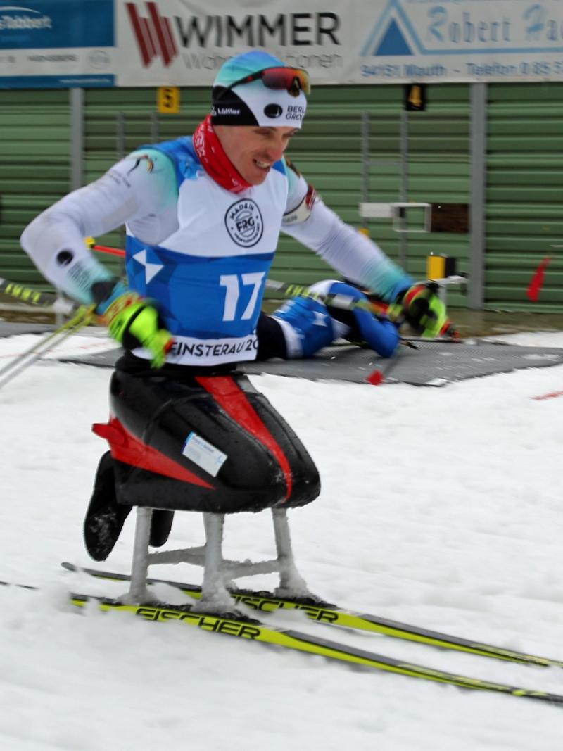 A male sit-skier competing on the snow