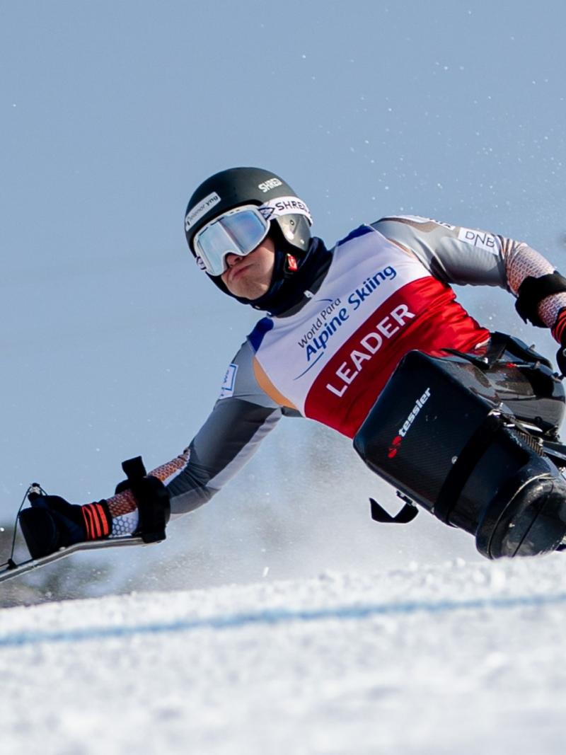 A male sit-skier competing on the snow