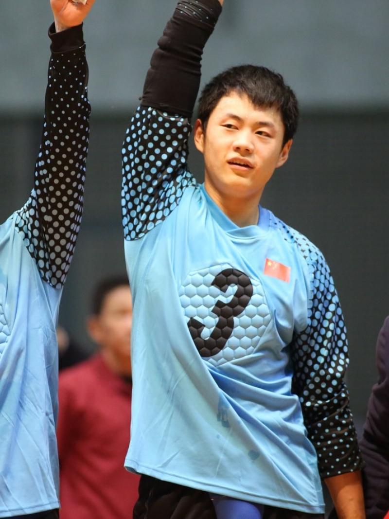 Chinese goalball players lift their arms after a victory