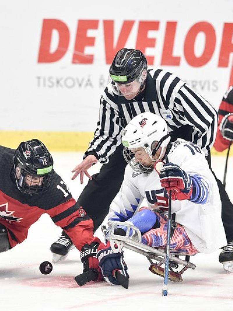 Greg Westlake (CAN) and Declan Farmer (USA) battle for the puck