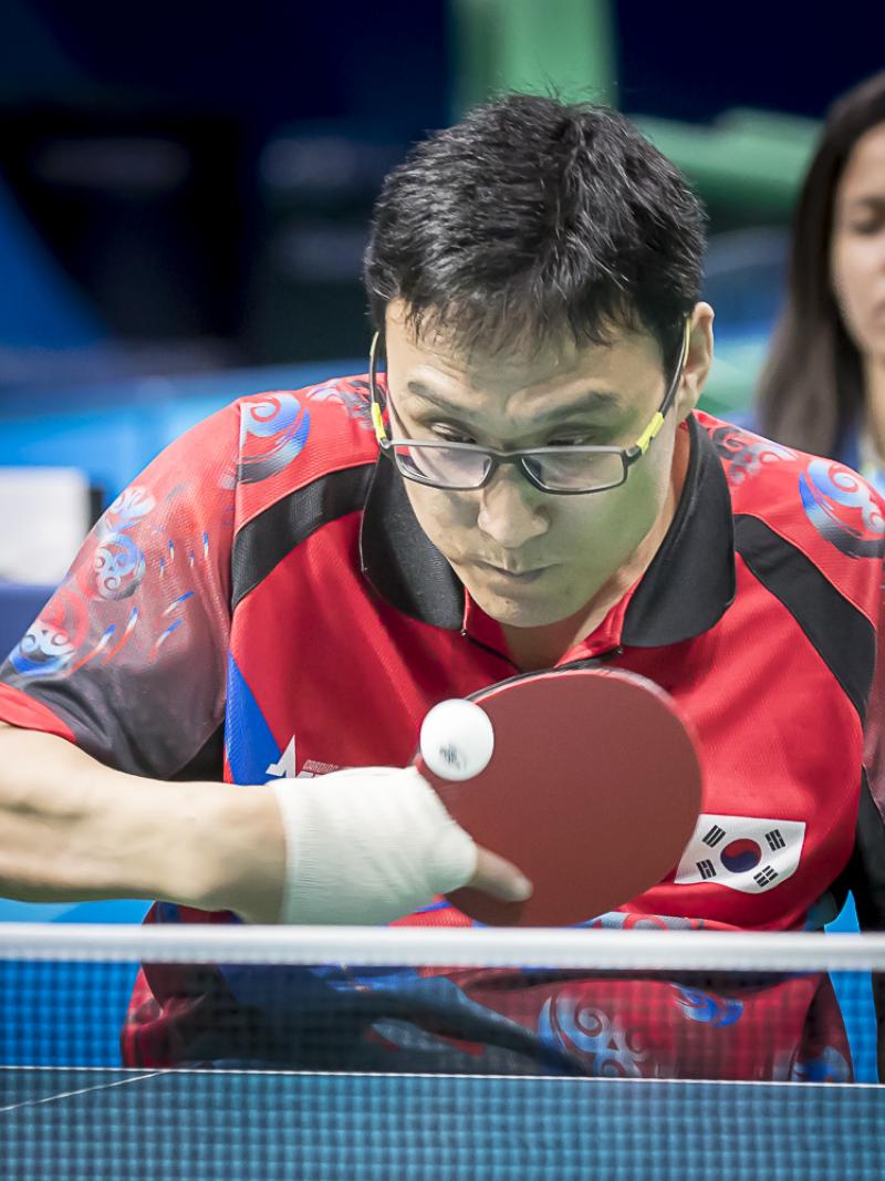 Korean male in wheelchair hits return shot in table tennis