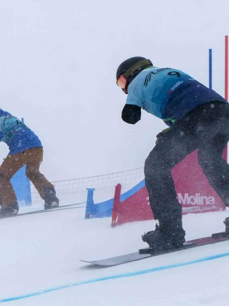 Two Para snowboarders competing side by side