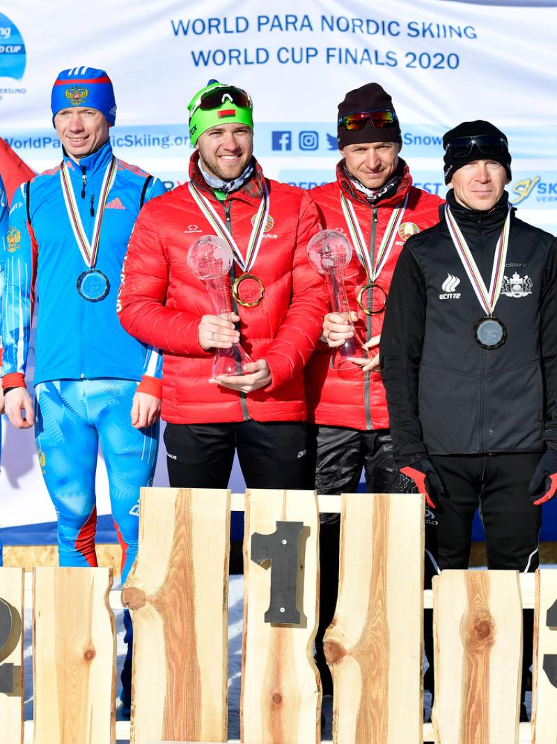 Six men standing on a podium with their medals