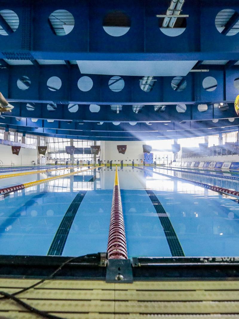 Two female Para swimmers jumping in the swimming pool