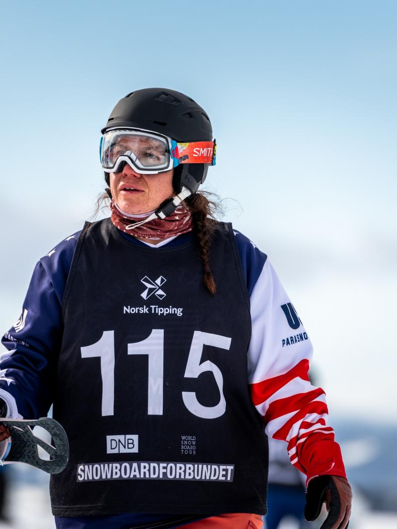 A woman holding her snowboard