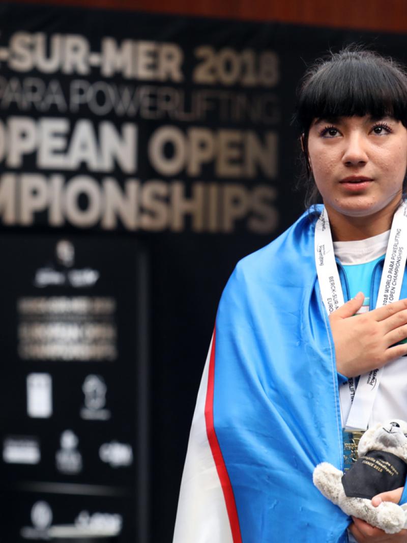 Shakhzoda Mamadalieva touching her chest with her right hand