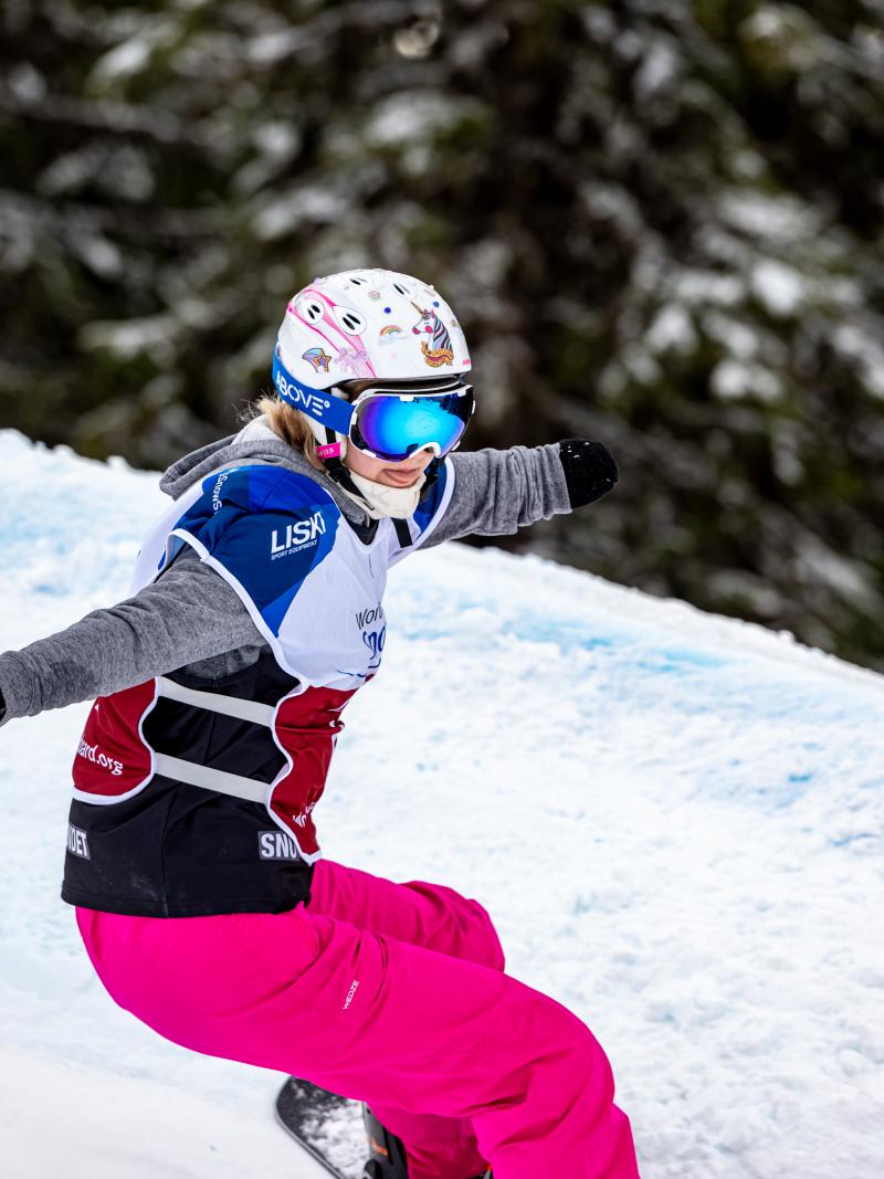 A female Para snowboarder competing 