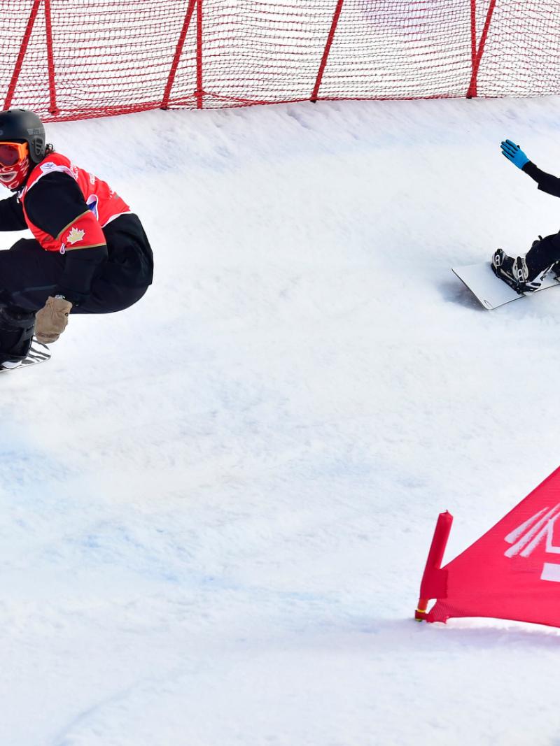 Two male Para snowboarders competing