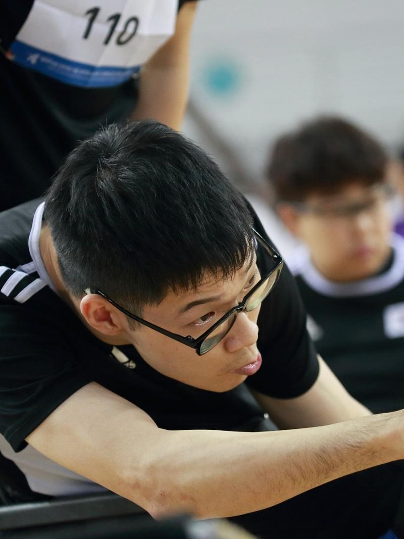 Korean male boccia player about to throw the ball