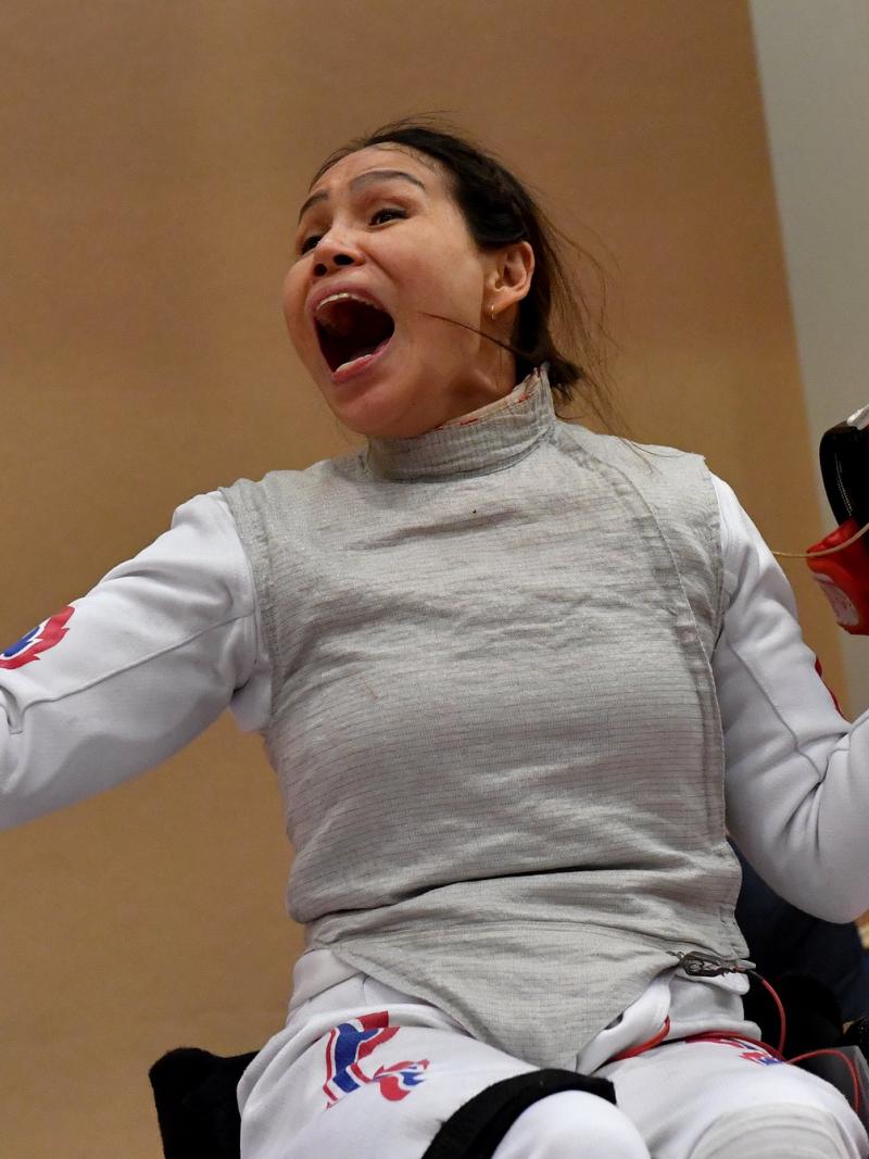 Female wheelchair fencer celebrates