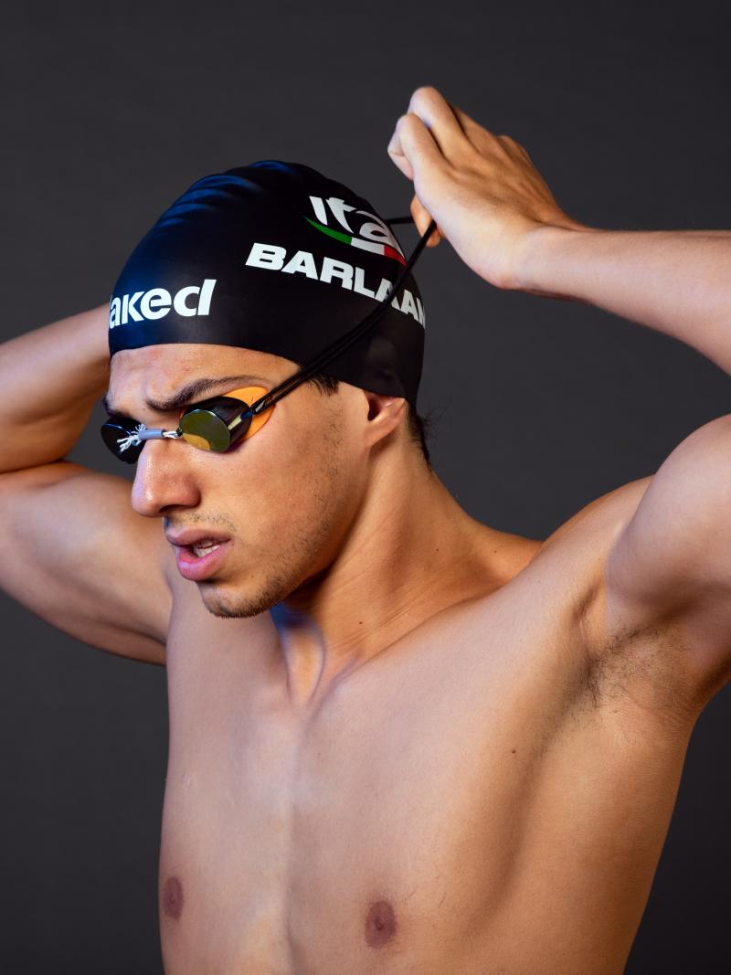 A male swimmer adjusting his swim cap