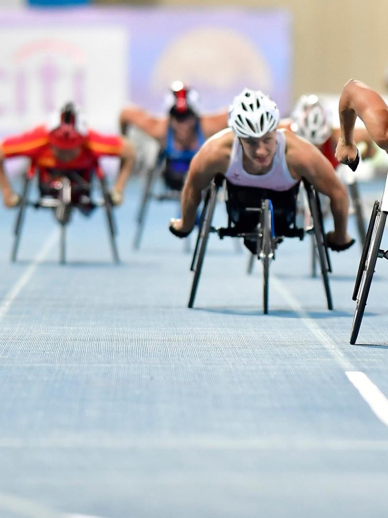 A group of female wheelchair racers on a track