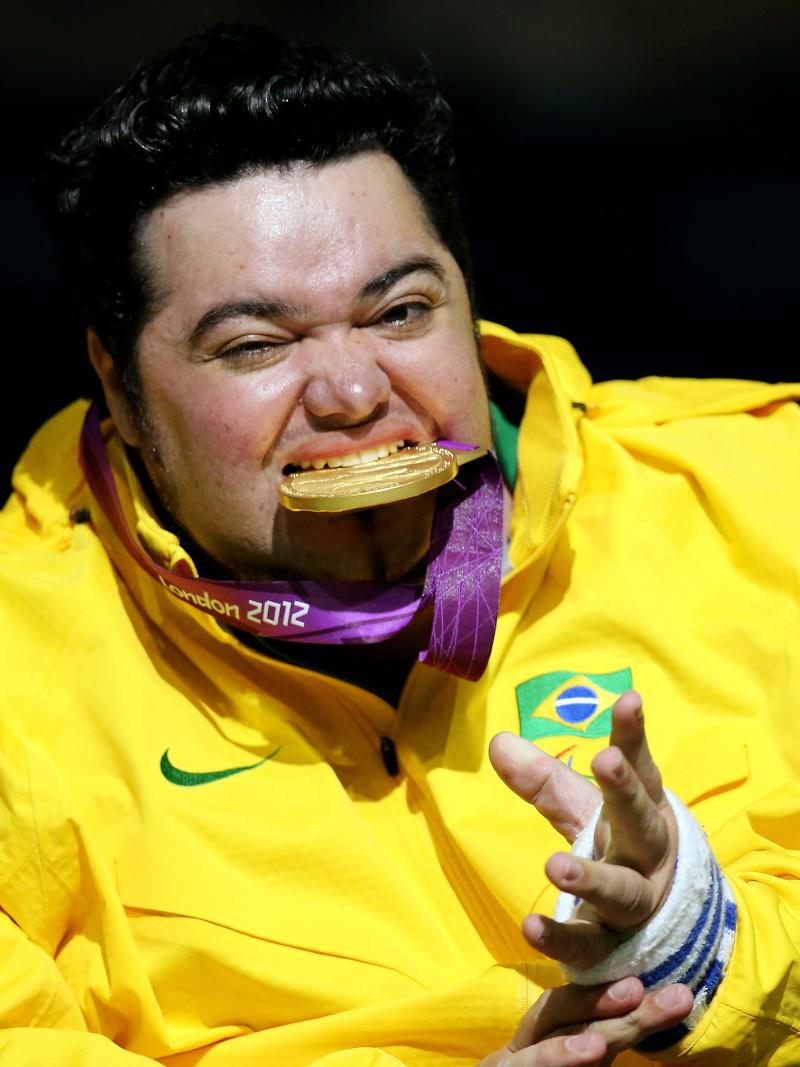 Male boccia player bites his Paralympic gold medal