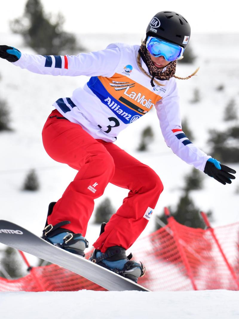 A female Para snowboarder competing