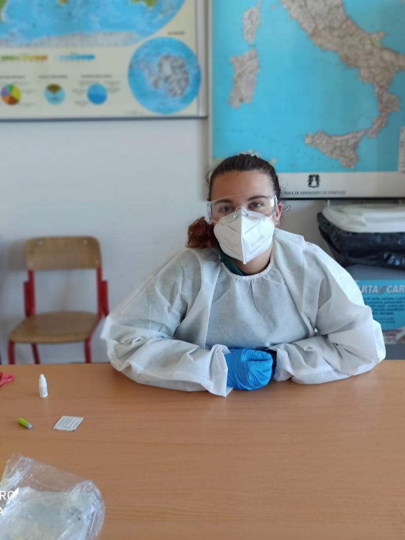 Italian female dressed in protective equipment with face mask, goggles and gloves