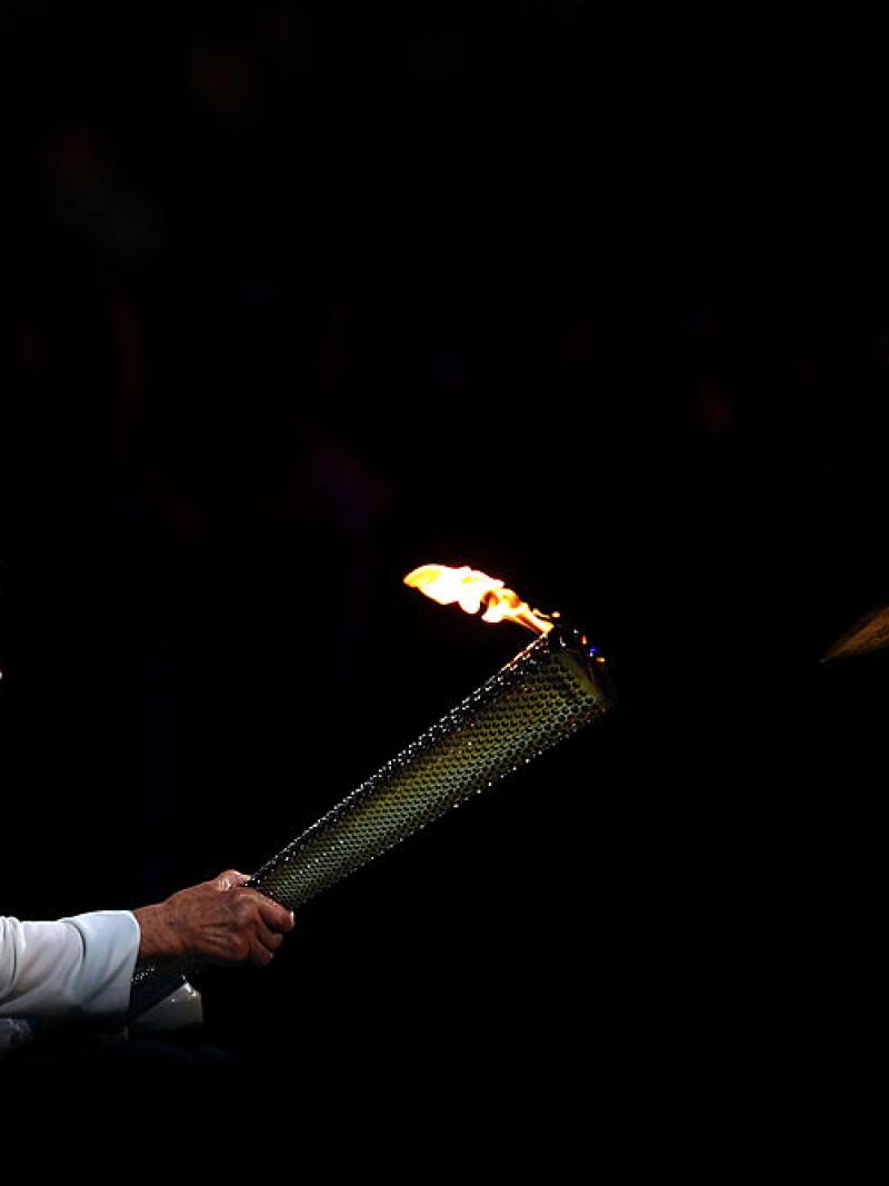 Older female woman in wheelchair lighting cauldron of Paralympic Games