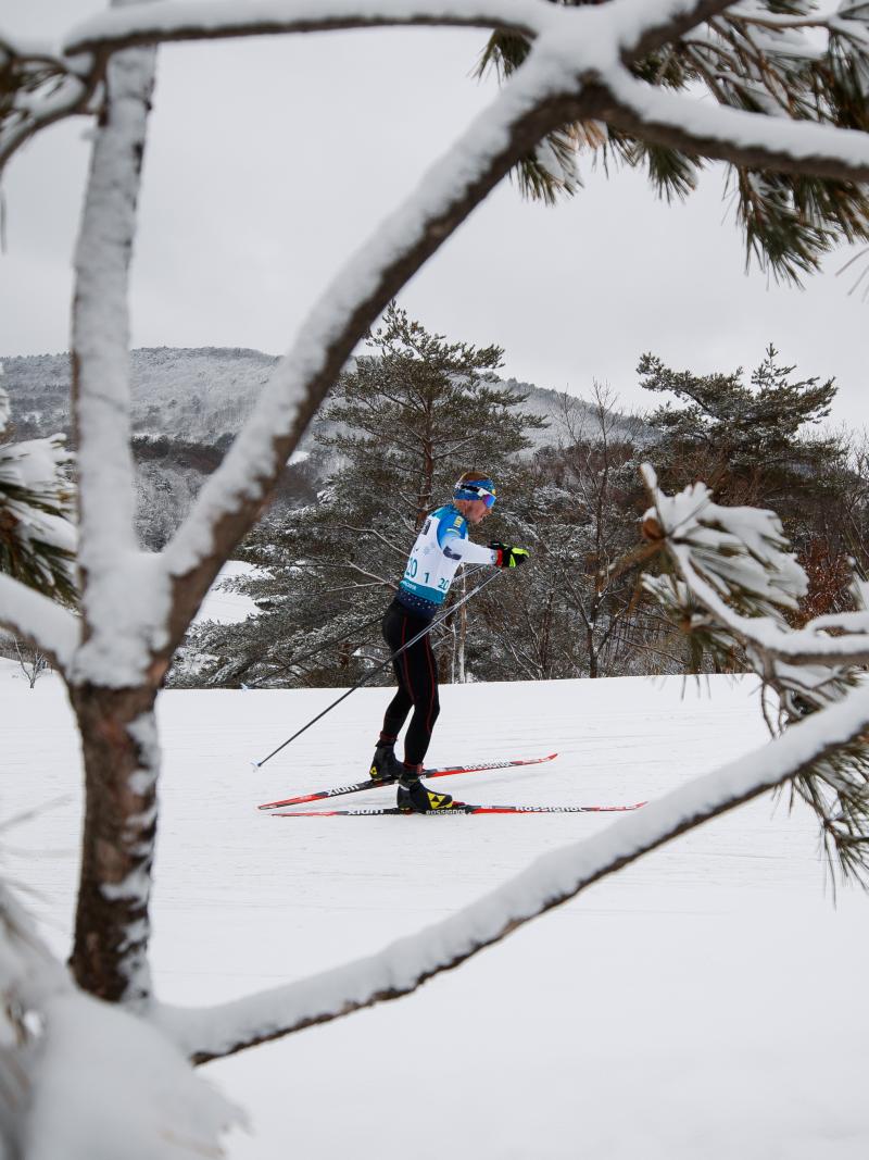 A man competing in cross-country in the snow