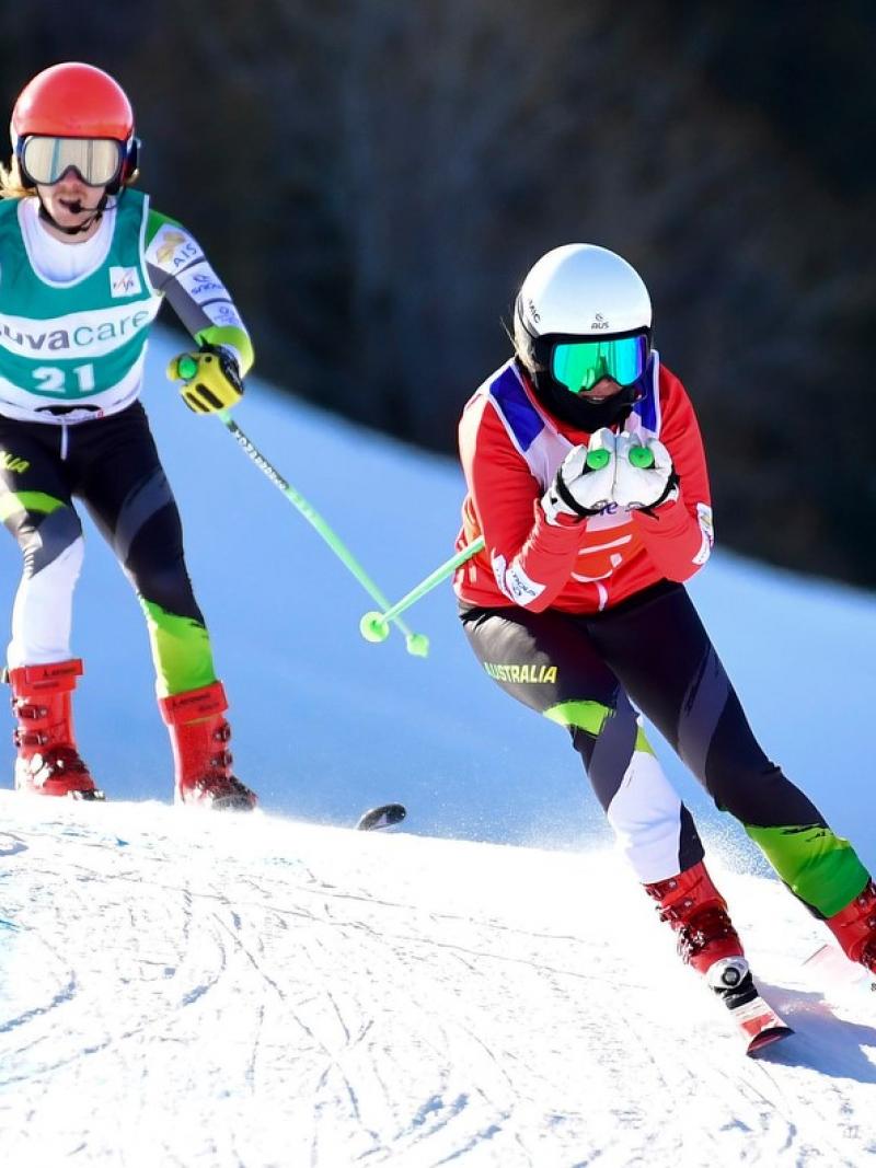 A female guide alpine skier ahead of a male Para alpine skier on a slope