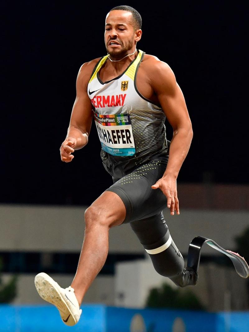 A man with a prosthetic leg jumping 