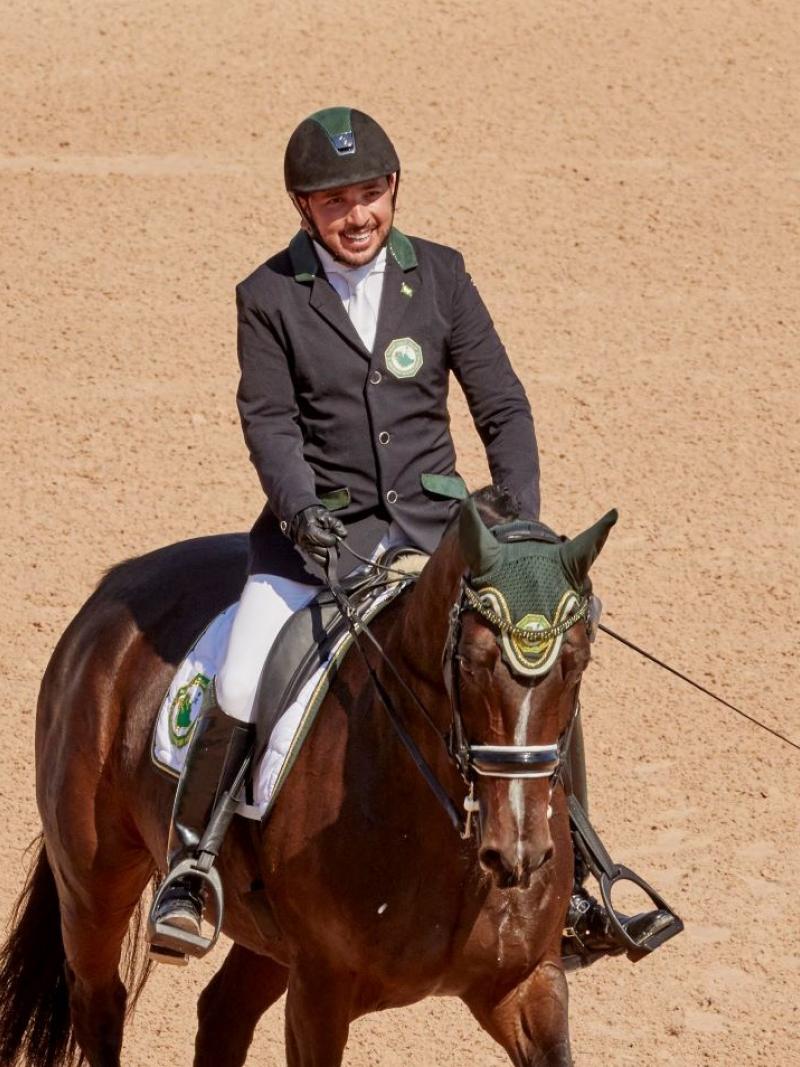 Saudia Arabian man riding a horse