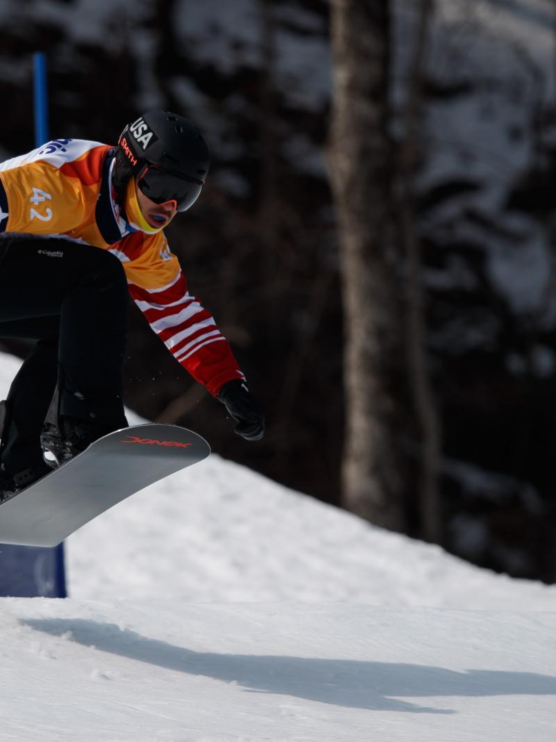 A male Para snowboarder competing 