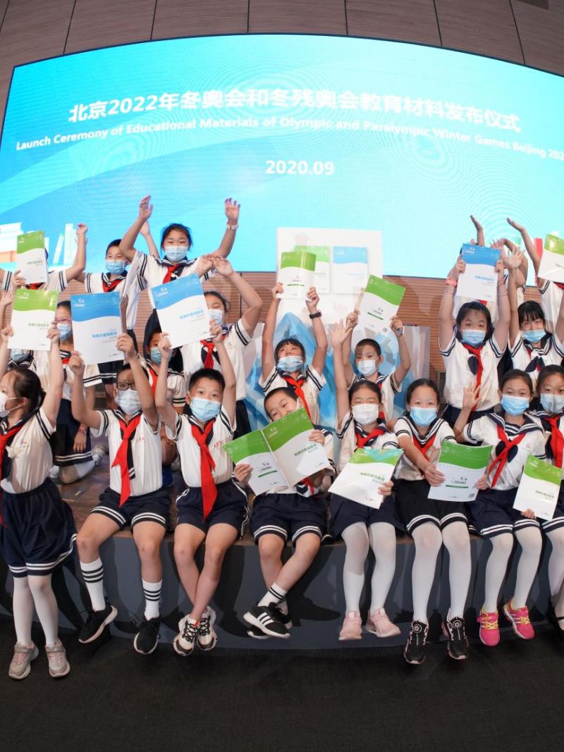 Chinese school kids with hands in the air