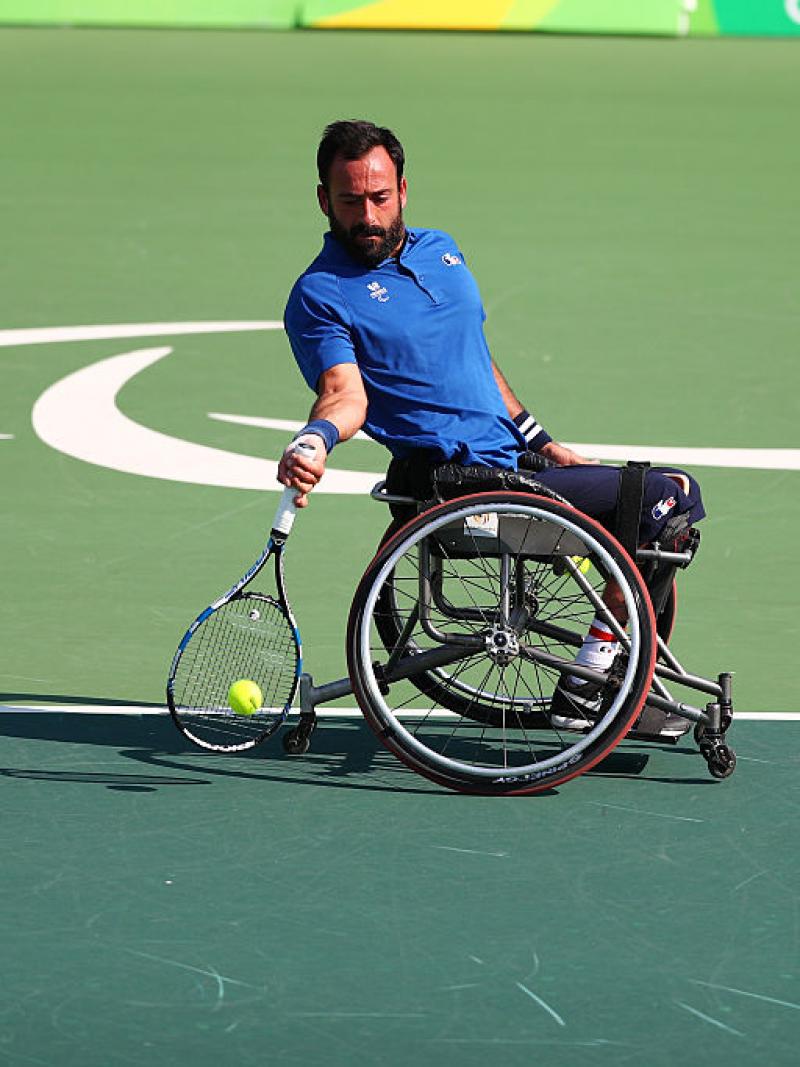 French man in wheelchair returns tennis shot