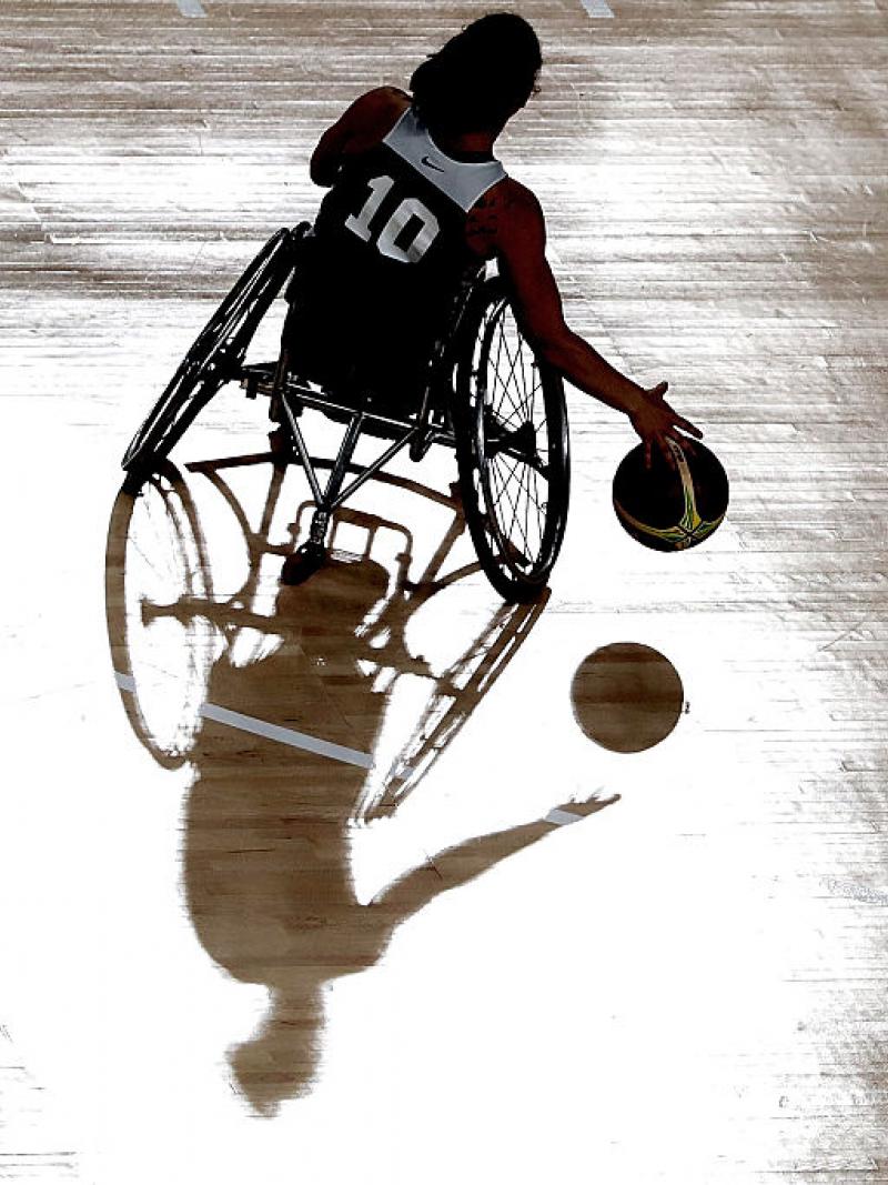 Female wheelchair basketball player dribble the ball