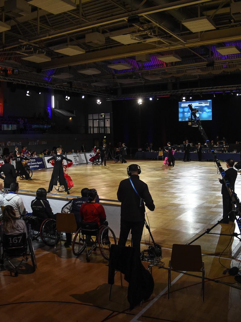 An external view of a Para dance sport venue with five couples competing