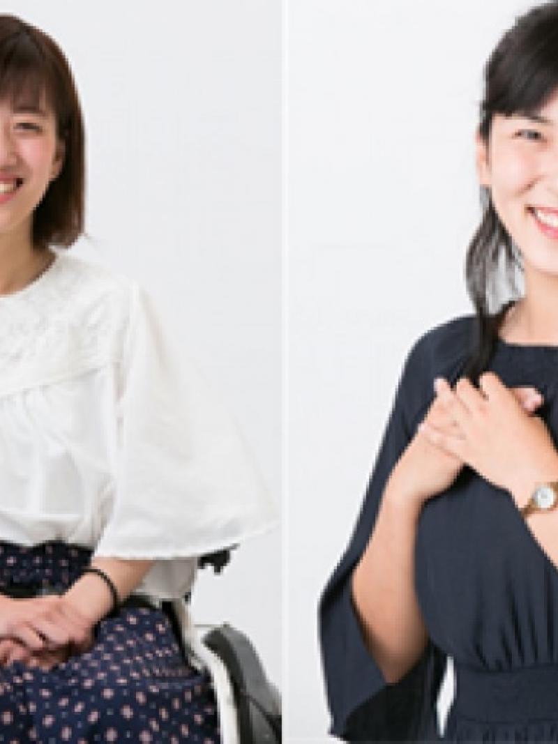 Two women posing, one of them in an electric wheelchair