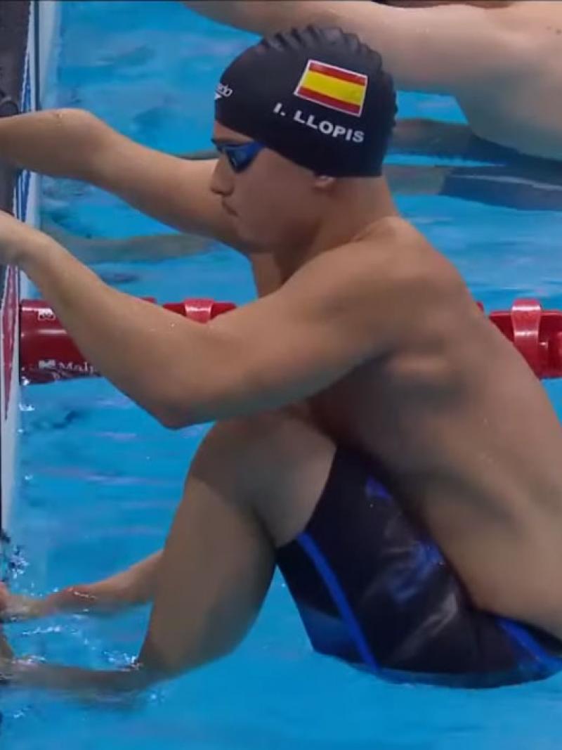 Male swimmer takes his mark on the block