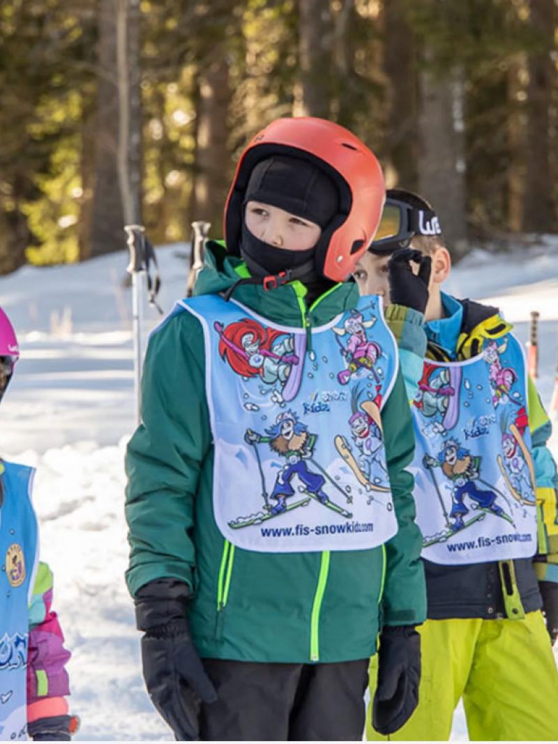 Four children and a man on the snow