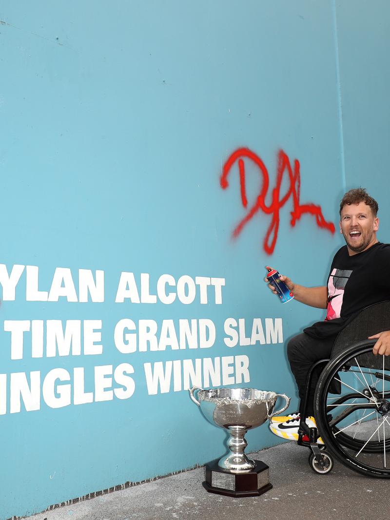 Male wheelchair tennis player next to wall art