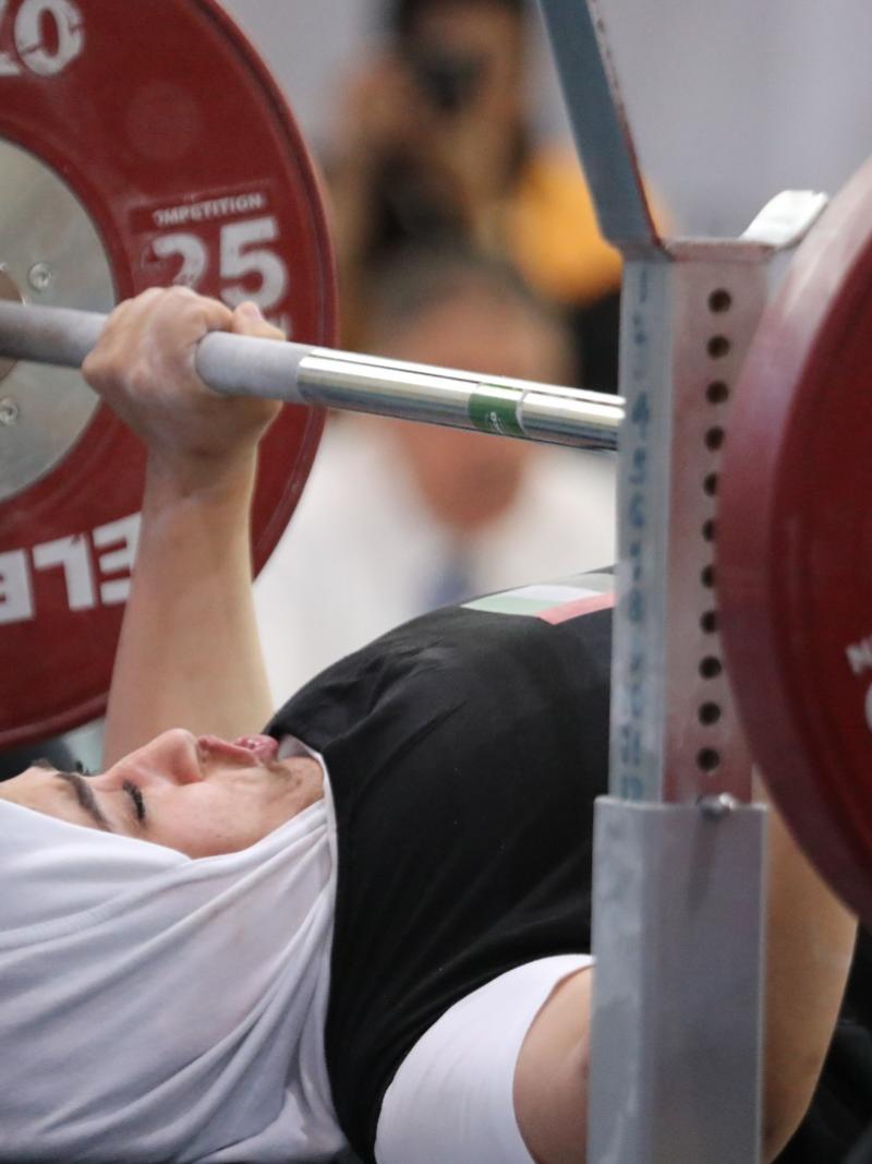 Female UAE powerlifter about to push the bar