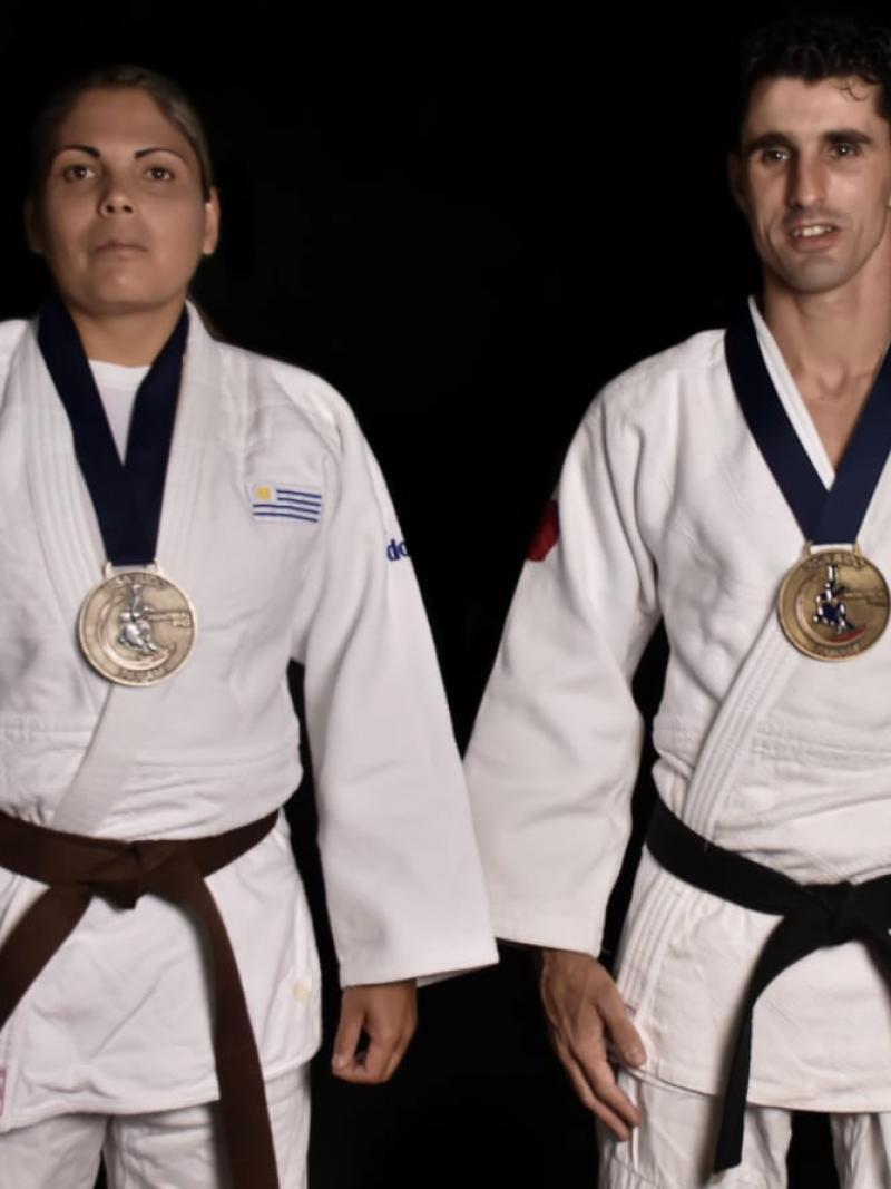 Henry Borges and Mariana Mederos standing with the Lima 2019 medals hanging on their necks