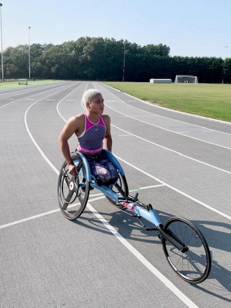 Black female wheelchair racer in her racing chair on the track