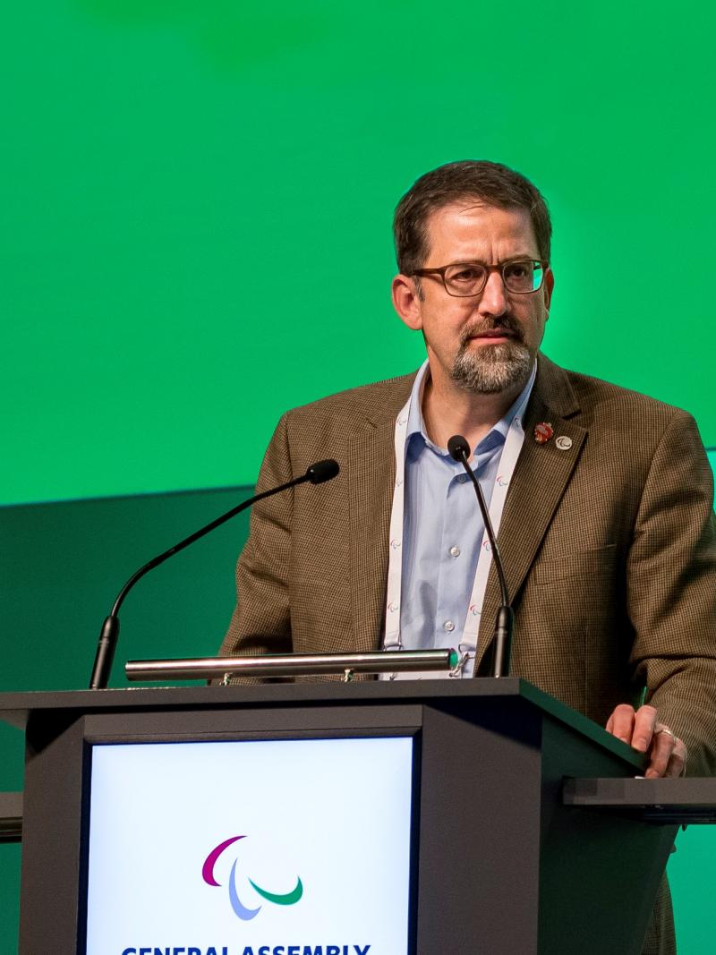 Man speaking on a podium