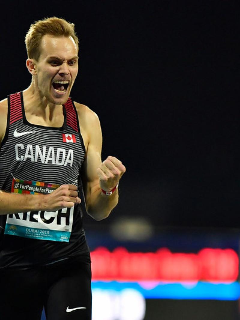 Canadian male distance runner celebrates