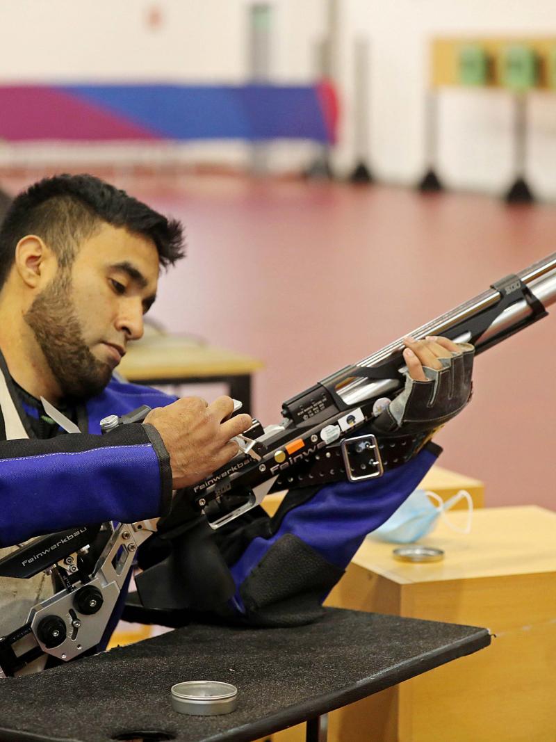 A man loading a rifle in a shooting range