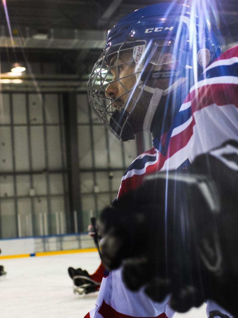 A male Para ice hockey player in an ice rink