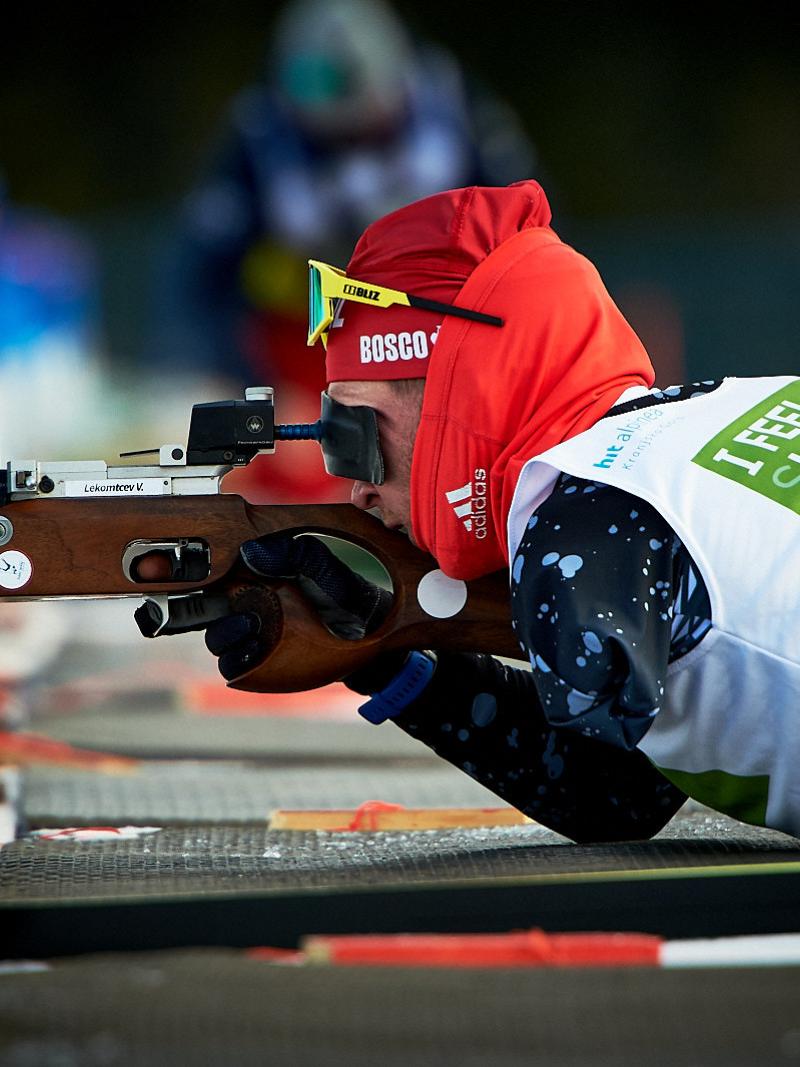 A men without the left arm shooting with a rifle during a Para biathlon competition