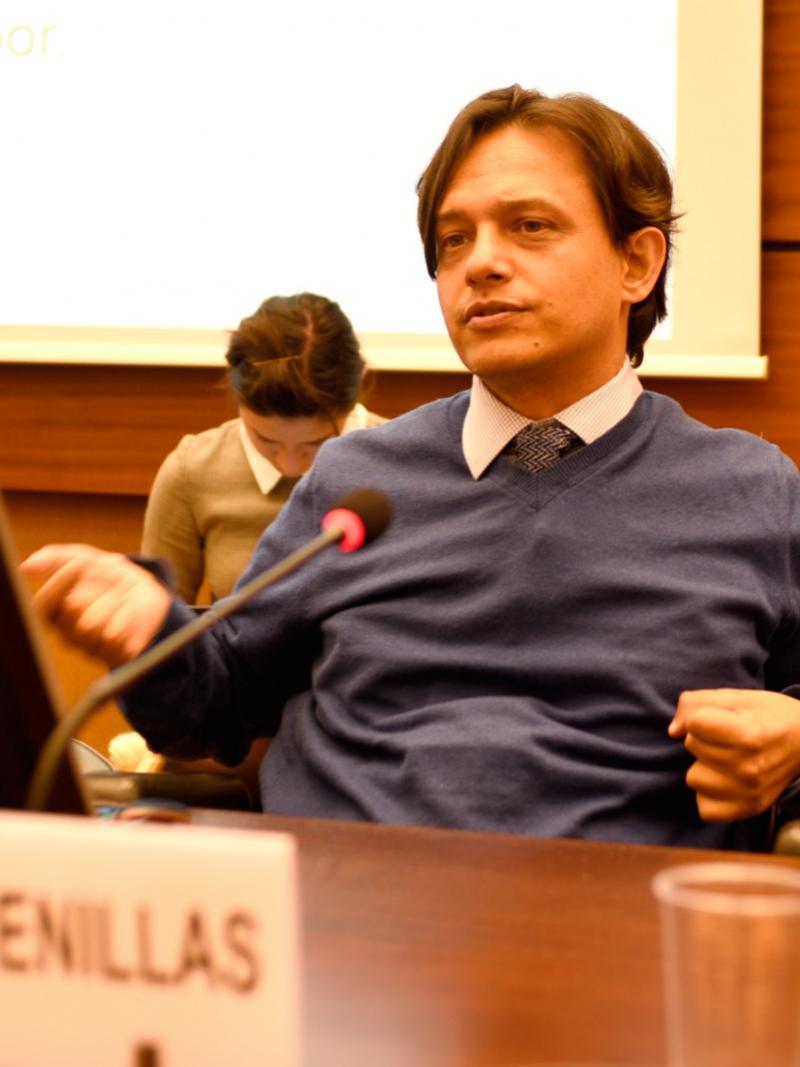 Man speaking at round table